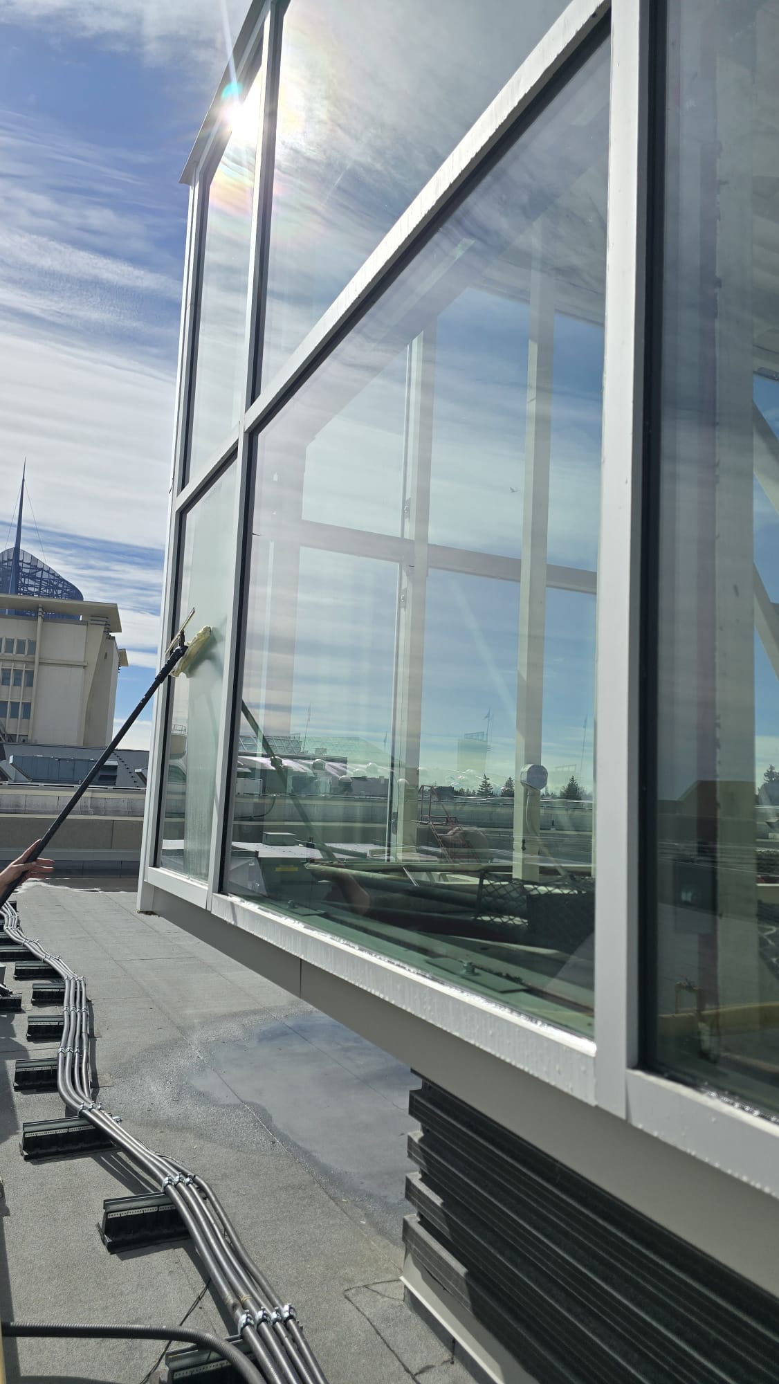 Refresh Exteriors team cleaning windows on a Calgary home
